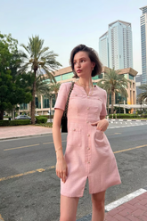 a lady in a pink slit dress